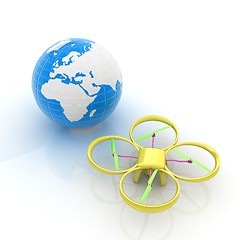 Image showing Quadrocopter Drone with Earth Globe and remote controller on a w