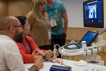 Image showing Participants learning new ultrasound techniques on medical congress.