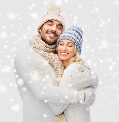 Image showing smiling couple in winter clothes hugging