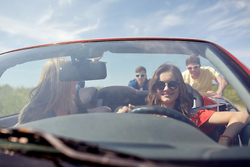 Image showing happy friends pushing broken cabriolet car