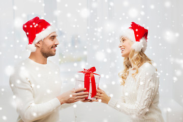 Image showing happy couple at home with christmas gift box