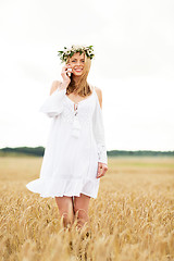 Image showing happy young woman calling on smartphone at country