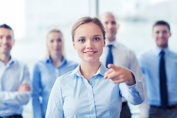 Image showing smiling businesswoman pointing finger on you