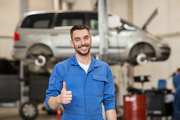 Image showing happy auto mechanic man or smith at car workshop