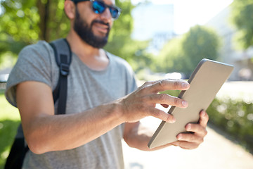 Image showing close up of man with tablet pc and bag in city