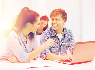 Image showing two smiling students with laptop computer