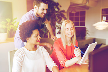 Image showing happy creative team with computer in office