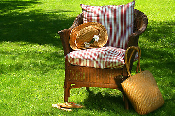 Image showing Straw hat and old wicker chair