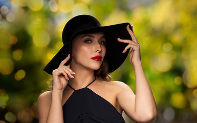 Image showing beautiful woman in black hat over dark background