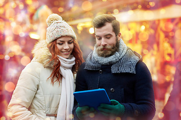 Image showing happy couple walking with tablet pc in old town
