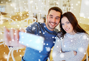 Image showing couple taking smartphone selfie at cafe restaurant