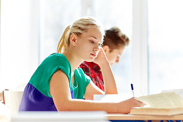 Image showing group of students with books writing school test