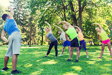 Image showing group of friends or sportsmen exercising outdoors