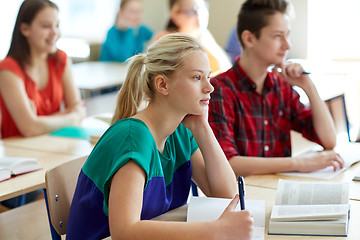 Image showing group of students with books writing school test