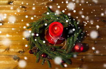 Image showing fir branch wreath with candle on wooden table