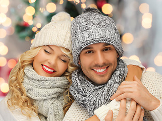 Image showing happy family couple in winter clothes hugging