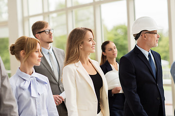 Image showing business team in helmets walking along office