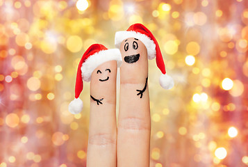 Image showing close up of two fingers with smiley and santa hats