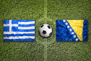 Image showing Greece vs. Bosnia and Herzegovina flags on soccer field