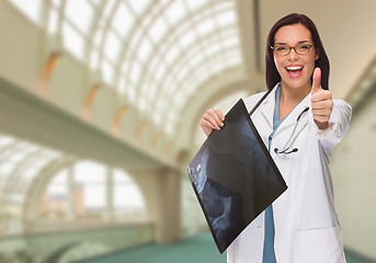 Image showing Happy Female Doctor or Nurse Holding X-ray Inside Hospital.