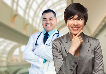 Image showing Male Doctor Stands Behind Woman Looking To Side Inside Hospital