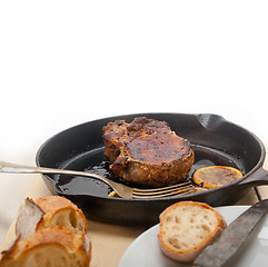 Image showing pork chop seared on iron skillet