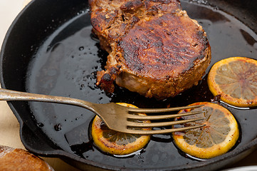 Image showing pork chop seared on iron skillet