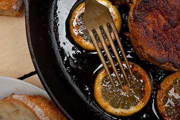 Image showing pork chop seared on iron skillet