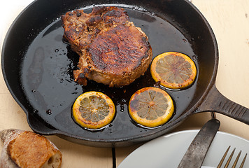 Image showing pork chop seared on iron skillet