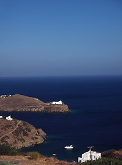 Image showing church monastery on promontory in Aegean Sea with houses and boa