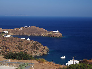 Image showing church monastery on promontory in Aegean Sea with houses and boa