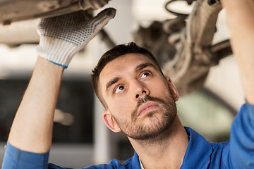 Image showing mechanic man or smith repairing car at workshop