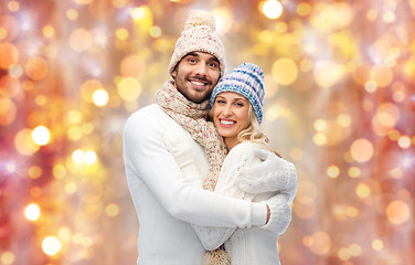 Image showing smiling couple in winter clothes hugging