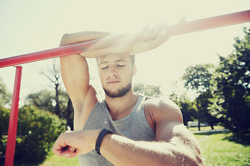 Image showing man with heart-rate watch exercising outdoors