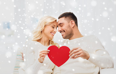 Image showing happy couple with red heart hugging at home