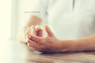 Image showing close up of woman with transparent smartphone