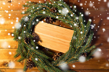 Image showing natural green fir branch wreath and wooden board