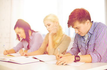 Image showing tired students with notebooks at school