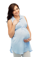 Image showing happy pregnant woman touching her big belly