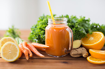 Image showing glass jug of carrot juice, fruits and vegetables