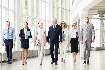 Image showing business people walking along office building