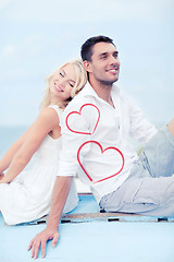 Image showing couple sitting on boat at sea side