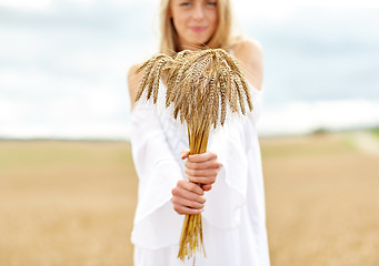 Image showing close up of happy woman with cereal spikelets