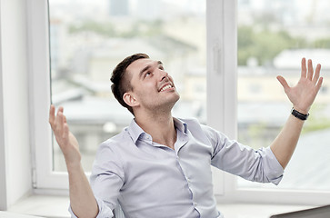 Image showing happy businessman with laptop in office