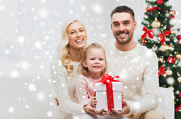 Image showing happy family at home with christmas gift box