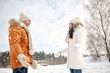 Image showing happy couple playing with snow in winter