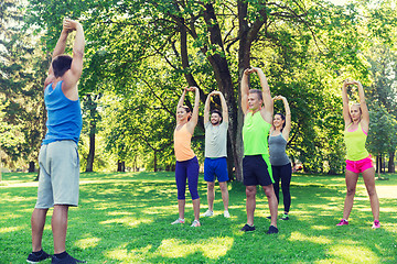 Image showing group of friends or sportsmen exercising outdoors