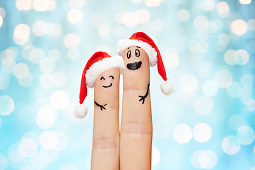 Image showing close up of two fingers with smiley and santa hats