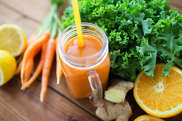 Image showing glass jug of carrot juice, fruits and vegetables