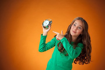 Image showing The cute cheerful little girl on orange background